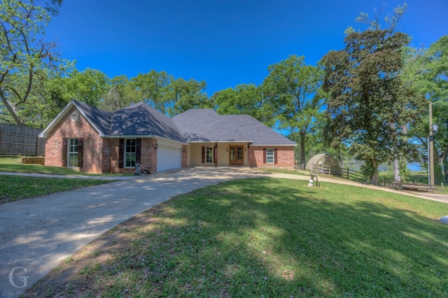 ranch-style house featuring a front yard and a garage