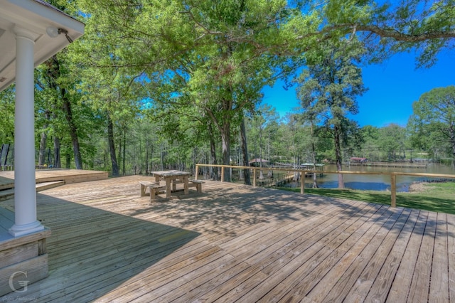 wooden terrace featuring a water view