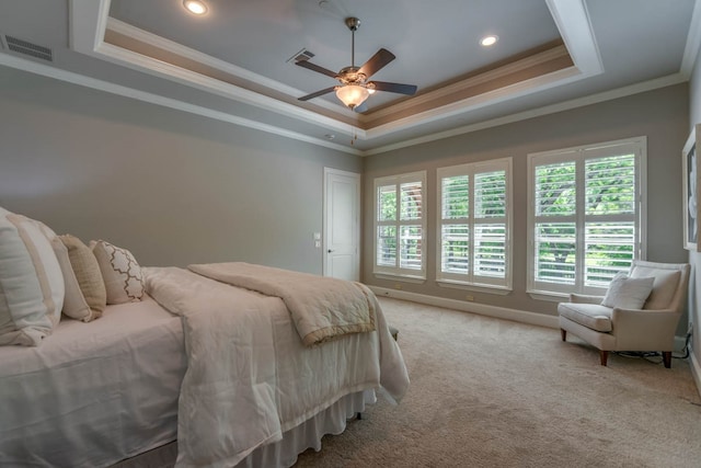 bedroom featuring ornamental molding, a tray ceiling, carpet, and ceiling fan