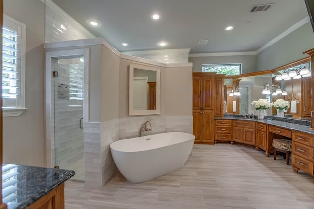 bathroom featuring vanity, tile walls, separate shower and tub, and crown molding