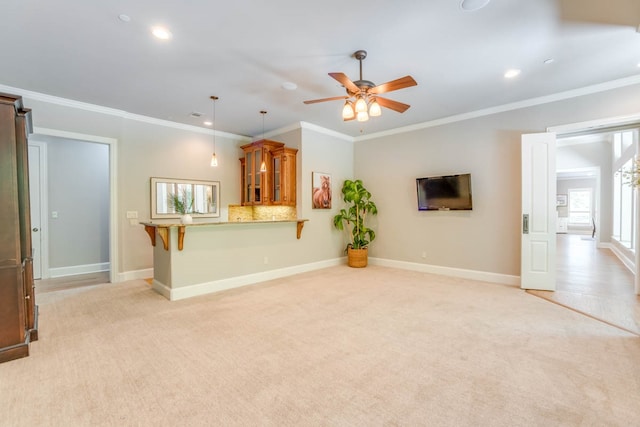 unfurnished living room with light carpet, ornamental molding, a barn door, and ceiling fan