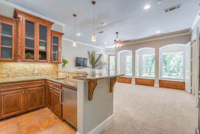 kitchen with kitchen peninsula, a breakfast bar area, stainless steel dishwasher, crown molding, and light colored carpet