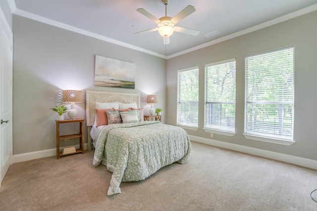 carpeted bedroom with ornamental molding and ceiling fan