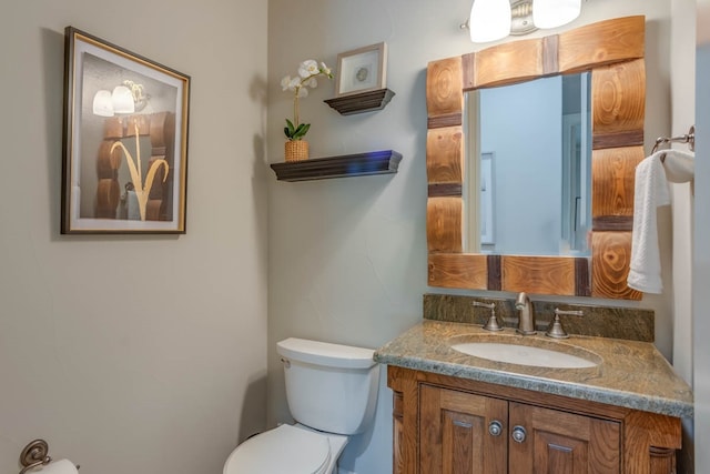 bathroom featuring toilet and vanity