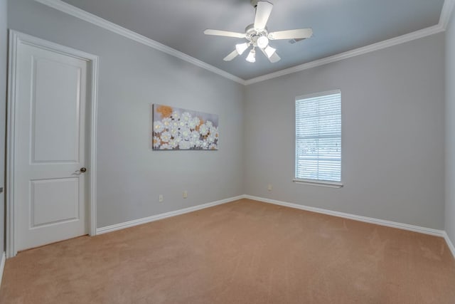 carpeted empty room featuring crown molding and ceiling fan