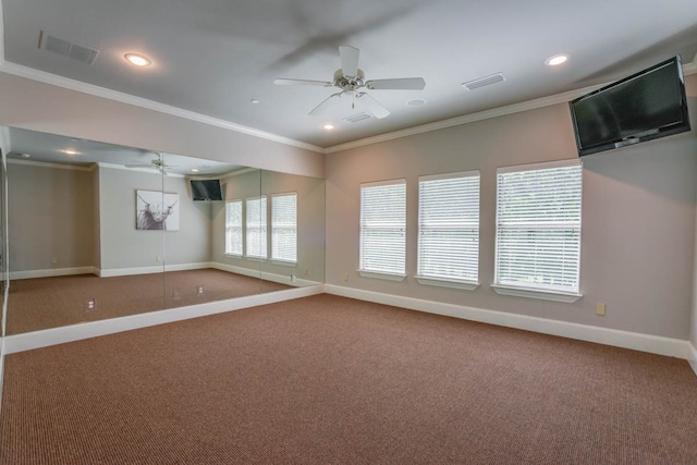 carpeted spare room featuring ornamental molding and ceiling fan