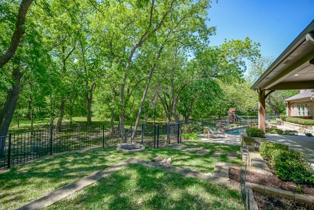 view of yard featuring an outdoor fire pit, a patio area, and a playground