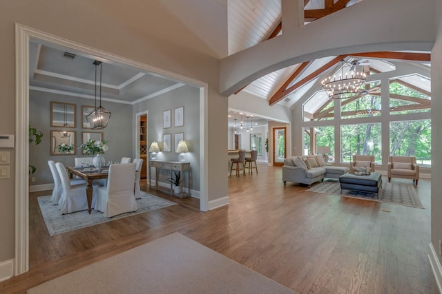 living room with lofted ceiling with beams and wood-type flooring