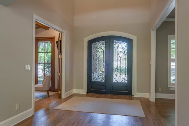 entrance foyer featuring french doors and wood-type flooring