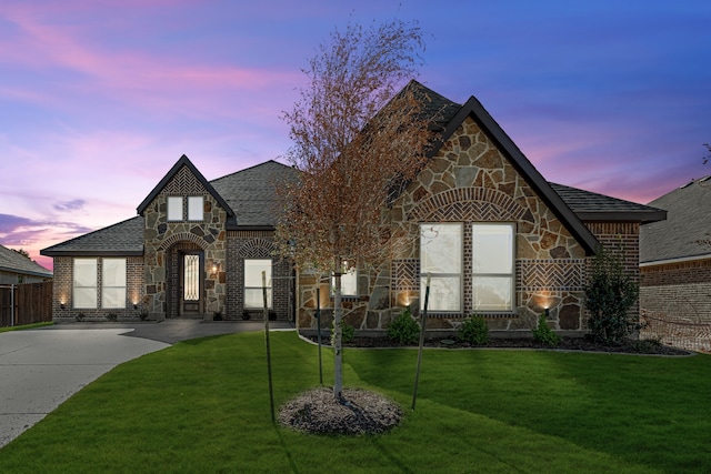 tudor house featuring a yard