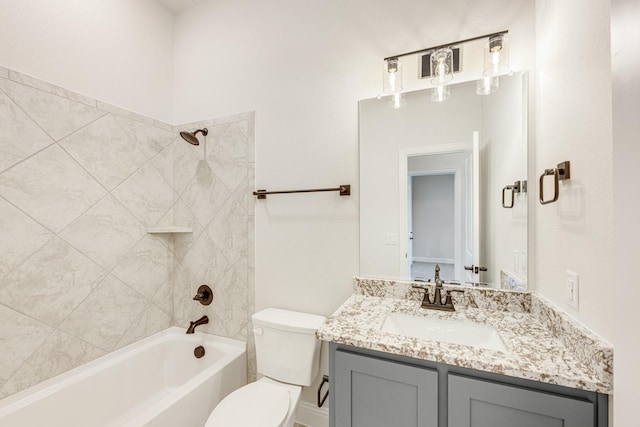 full bathroom featuring tiled shower / bath, vanity, and toilet