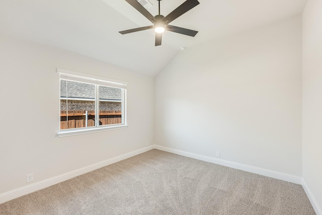 carpeted empty room featuring ceiling fan and lofted ceiling