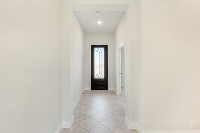 doorway to outside with light tile patterned floors