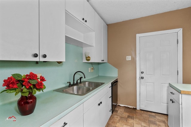 kitchen with light tile floors, dishwasher, white cabinets, and sink