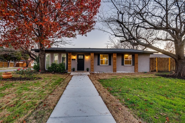 ranch-style home with a front yard