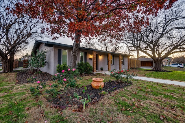 ranch-style home with a lawn