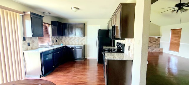 kitchen with backsplash, ceiling fan, black dishwasher, dark hardwood / wood-style floors, and sink