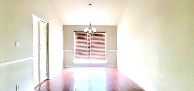 unfurnished dining area with light wood-type flooring and an inviting chandelier