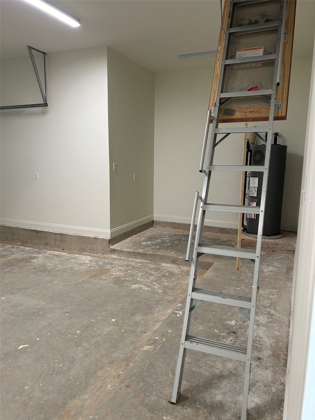 basement with baseboards and water heater