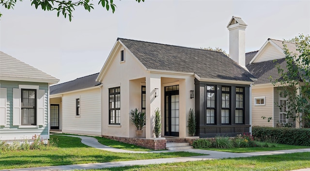 view of front of home with a front lawn and stucco siding