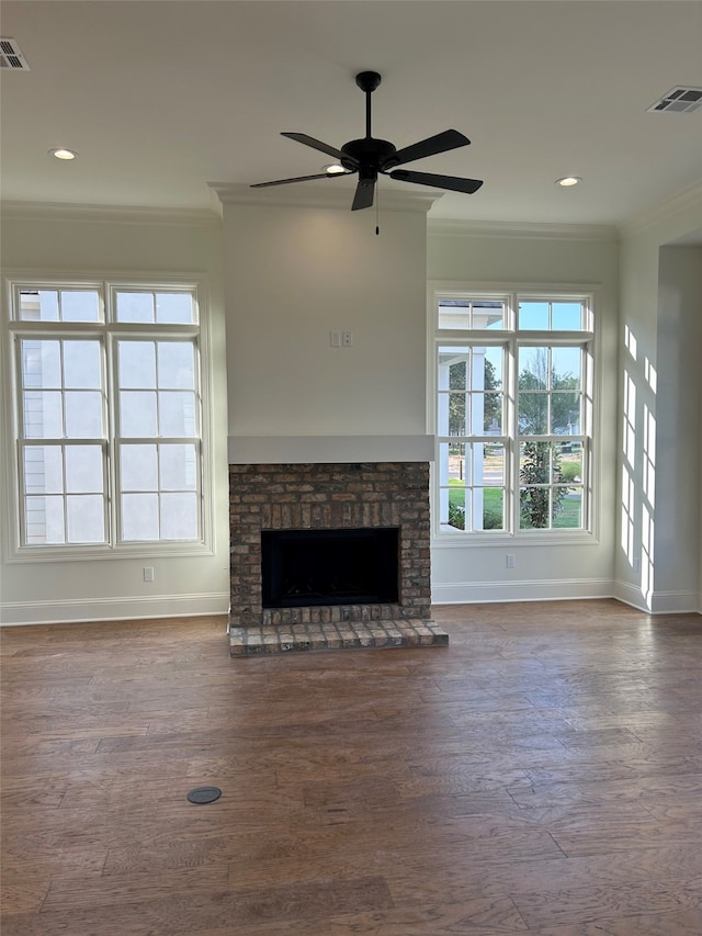 unfurnished living room featuring dark wood finished floors, a fireplace, crown molding, and baseboards