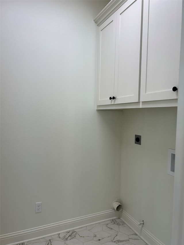 washroom featuring baseboards, hookup for a gas dryer, cabinet space, electric dryer hookup, and marble finish floor