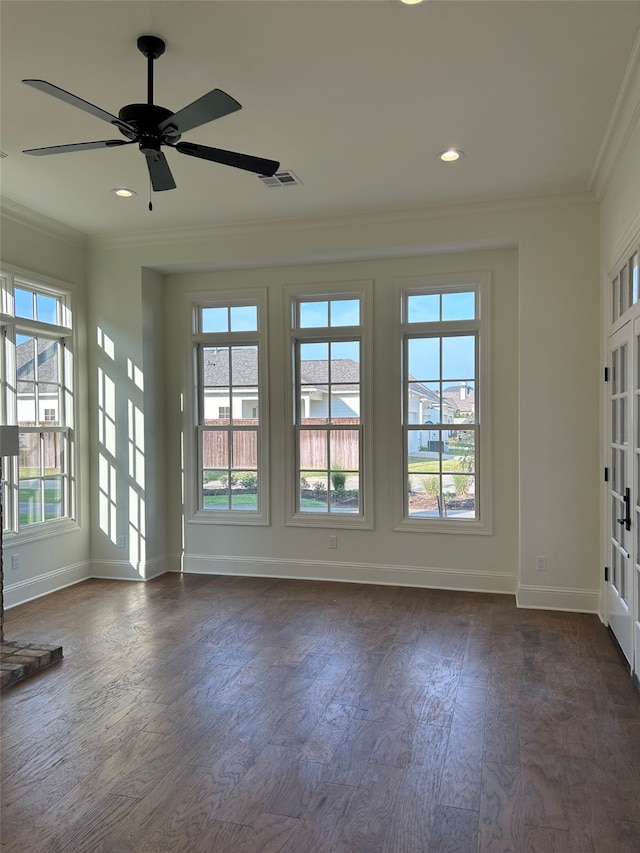 empty room featuring dark wood-style floors, baseboards, recessed lighting, ceiling fan, and ornamental molding