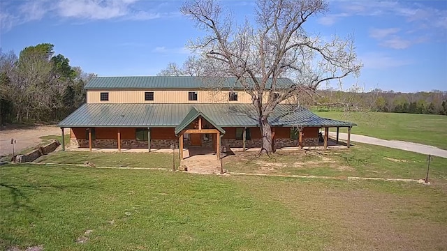 rear view of house featuring a lawn