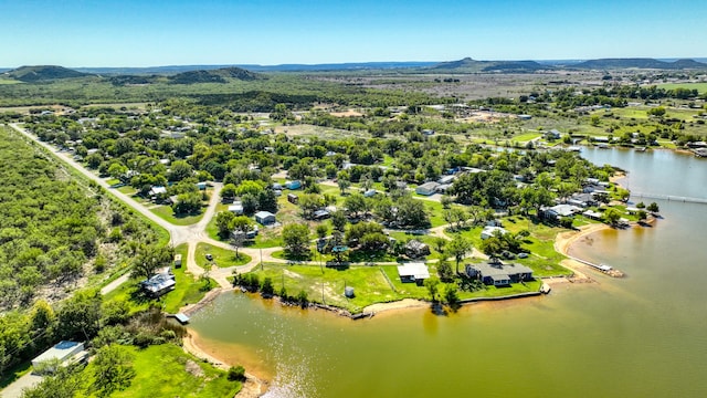 drone / aerial view with a water and mountain view