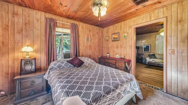 bedroom featuring ceiling fan, wooden walls, hardwood / wood-style flooring, wooden ceiling, and access to exterior