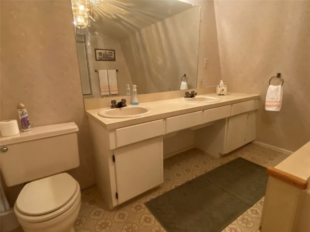 bathroom featuring double vanity, toilet, and tile floors