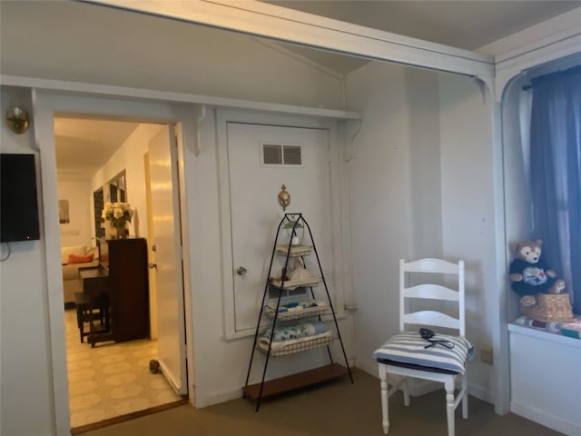 hallway with dark tile flooring