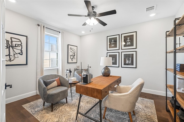 home office with dark hardwood / wood-style floors and ceiling fan