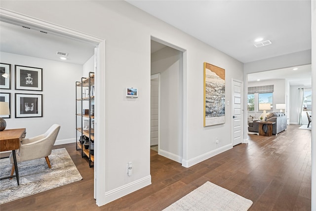 corridor with dark hardwood / wood-style floors