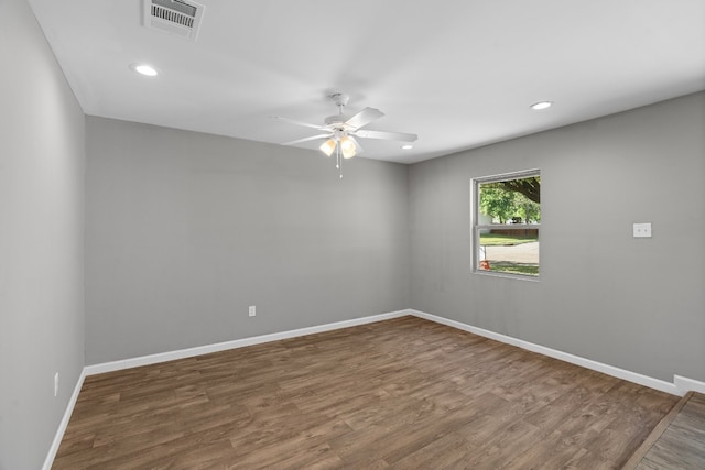 empty room with dark hardwood / wood-style flooring and ceiling fan