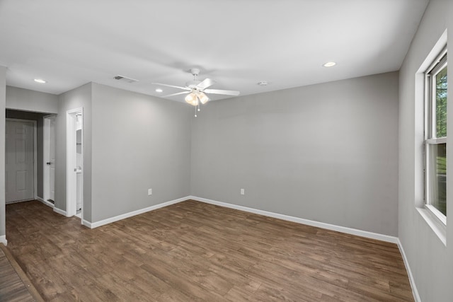 unfurnished room with ceiling fan and dark hardwood / wood-style floors