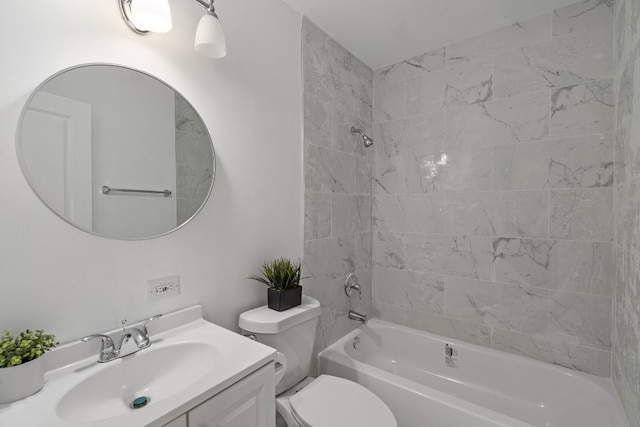 full bathroom with tiled shower / bath, toilet, and vanity