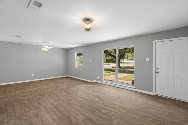 unfurnished room featuring ceiling fan and dark wood-type flooring