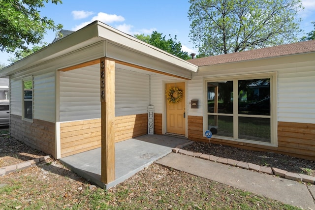 entrance to property with a patio area