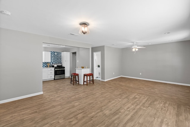 interior space with light hardwood / wood-style floors and ceiling fan