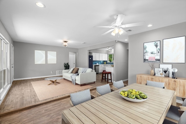 dining room featuring light hardwood / wood-style flooring, a healthy amount of sunlight, and ceiling fan