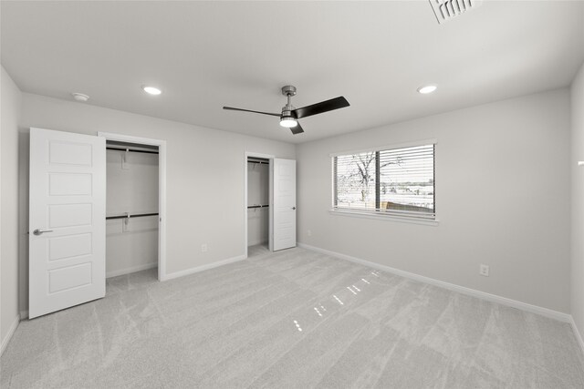 unfurnished bedroom featuring light colored carpet and ceiling fan