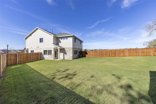 back of house featuring a yard