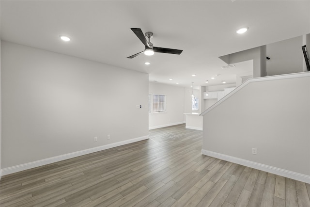 unfurnished living room featuring light hardwood / wood-style flooring and ceiling fan