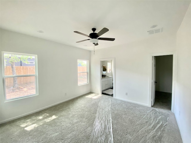 spare room featuring carpet and ceiling fan