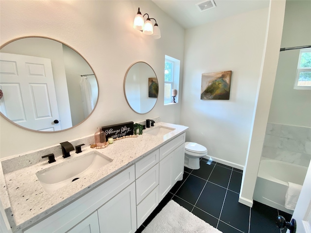 bathroom featuring dual vanity, tile patterned flooring, and toilet