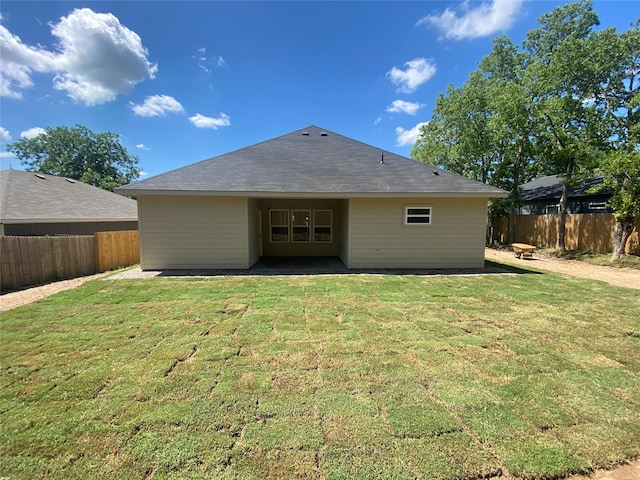 rear view of house with a lawn