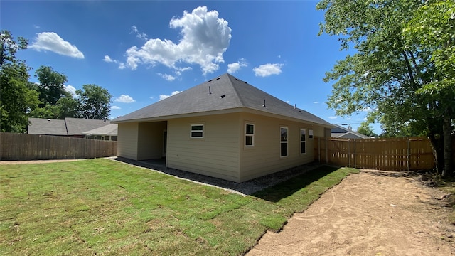 rear view of property featuring a yard