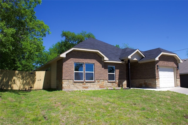 view of front of home with a garage and a front lawn