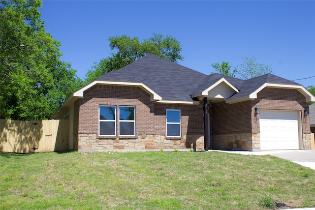 view of front of house with a garage and a front lawn